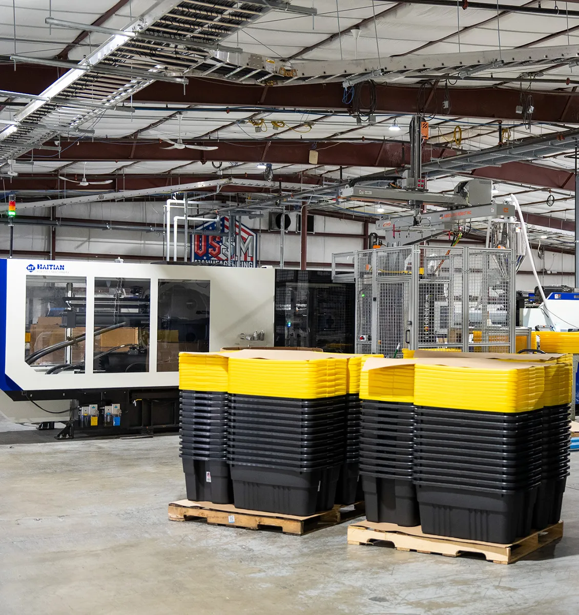 USSM LLC manufacturing facility with injection molding machines and storage bins
